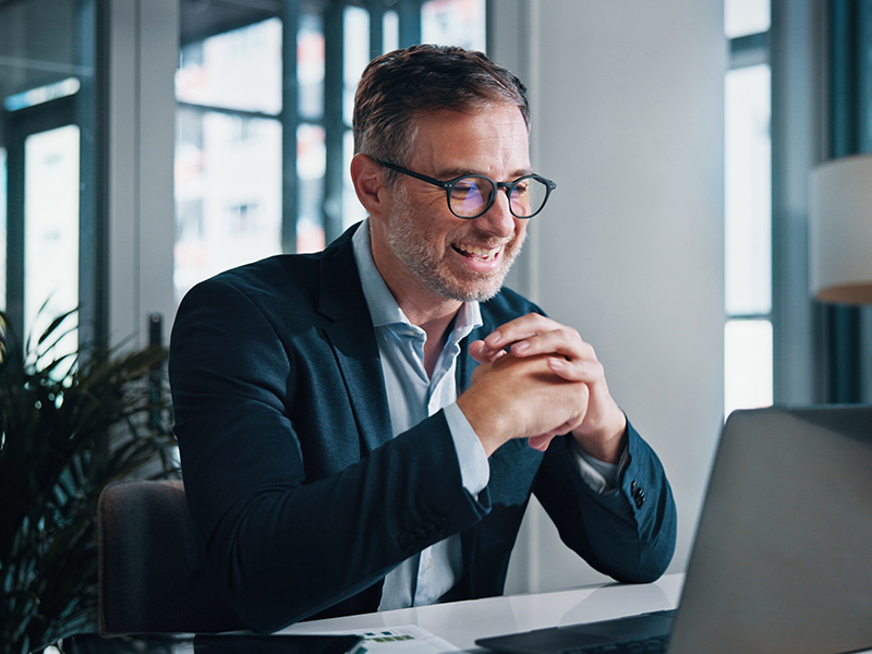 Broker, smile and mature businessman on laptop for finance, tax research and debt management. Investment banker, happy or advisor with technology for good news, financial account and report update