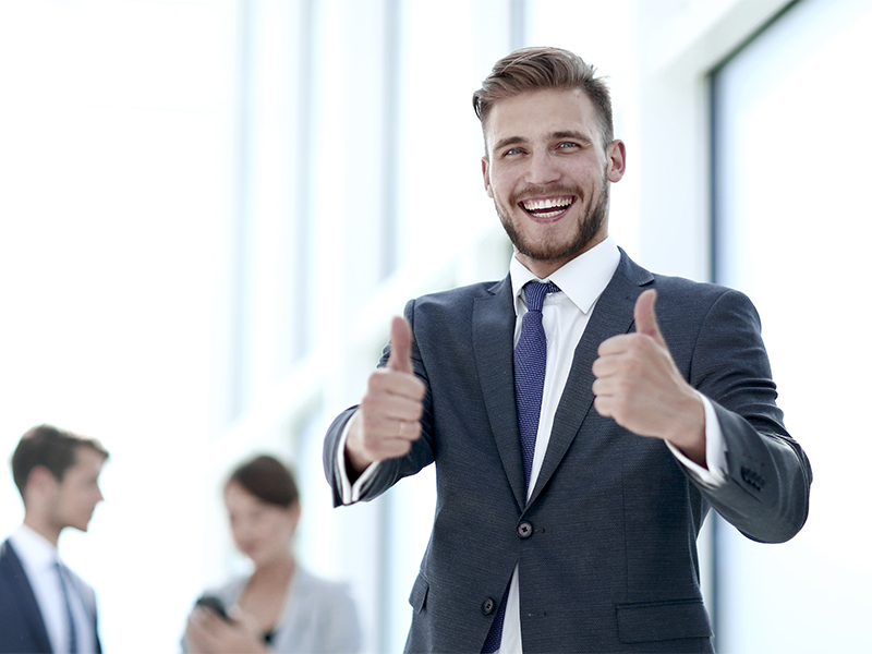 handsome businessman showing thumbs up